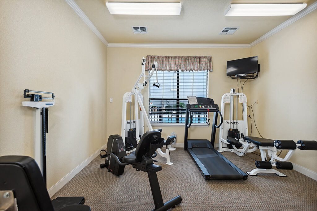 Fitness room with machines at Parkway Senior Apartments in Pasadena TX